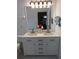 Bathroom featuring a double sink vanity with sleek hardware, framed mirror and stylish lighting at 223 Lady Diana Dr, Davenport, FL 33837