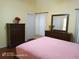 Spacious bedroom featuring wood floors and a traditional wooden dresser with a mirror at 223 Lady Diana Dr, Davenport, FL 33837
