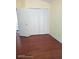 The empty bedroom has wood floors, yellow walls, a bright window, and closet space at 223 Lady Diana Dr, Davenport, FL 33837