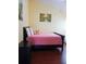 Comfortable bedroom with wood floors and pink bedding and Lion King doll on the bed at 223 Lady Diana Dr, Davenport, FL 33837