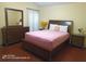 Bedroom with wood floors and wood furniture set, including a dresser and two nightstands at 223 Lady Diana Dr, Davenport, FL 33837