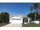 Attractive single-story home boasts a well-maintained lawn and attached two-car garage at 223 Lady Diana Dr, Davenport, FL 33837