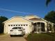 Charming home featuring a 2-car garage, screened porch, and well-manicured lawn at 223 Lady Diana Dr, Davenport, FL 33837