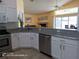 Well-lit kitchen featuring stainless steel appliances, white cabinets, and granite countertops overlooking the living area at 223 Lady Diana Dr, Davenport, FL 33837