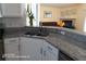 Bright kitchen with granite countertops and stainless steel sink overlooking the living room at 223 Lady Diana Dr, Davenport, FL 33837
