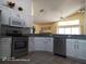 Bright kitchen with stainless appliances, granite counters, and seamless flow into the living area at 223 Lady Diana Dr, Davenport, FL 33837
