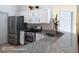 Modern kitchen with stainless steel appliances, granite countertops, and ample cabinet space at 223 Lady Diana Dr, Davenport, FL 33837