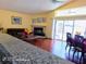 Inviting living room with a brick fireplace and sliding glass doors to the lanai and back yard at 223 Lady Diana Dr, Davenport, FL 33837