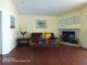 Inviting living room featuring a decorative fireplace, sofa, coffee table, and laminate flooring at 223 Lady Diana Dr, Davenport, FL 33837