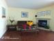 Comfortable living room with a fireplace and natural lighting, ideal for relaxation or entertaining at 223 Lady Diana Dr, Davenport, FL 33837