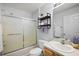 Modern bathroom with walk in shower, toilet, and decorative floating shelf at 2290 Due West Dr, The Villages, FL 32162