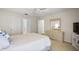 Comfortable bedroom with a ceiling fan, neutral paint, and adjacent dresser at 2290 Due West Dr, The Villages, FL 32162