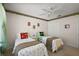 Bright bedroom features twin beds, a ceiling fan, and a closet providing ample storage at 2290 Due West Dr, The Villages, FL 32162