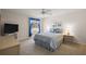 Cozy bedroom with a large window, TV, and neutral decor creating a relaxing and comfortable atmosphere at 2290 Due West Dr, The Villages, FL 32162