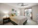 Comfortable bedroom with a ceiling fan, curtains, and two side tables with lamps at 2290 Due West Dr, The Villages, FL 32162