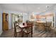 Inviting dining area with wood table, chandelier, and sliding glass doors to the patio, adjacent to the kitchen at 2290 Due West Dr, The Villages, FL 32162