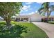 Inviting home featuring a manicured lawn, and charming curb appeal at 2290 Due West Dr, The Villages, FL 32162