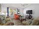 Cozy living room with modern flooring, comfortable sofas, a ceiling fan, and plenty of natural light at 2290 Due West Dr, The Villages, FL 32162