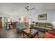 Spacious living room featuring an open-concept layout, modern flooring, comfortable seating, and a view into the kitchen at 2290 Due West Dr, The Villages, FL 32162