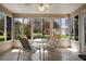 Relaxing sunroom features tile floors, a ceiling fan, and panoramic windows to the outdoors at 2290 Due West Dr, The Villages, FL 32162