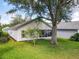 This lovely home boasts a spacious backyard with a screened lanai and mature trees at 25044 Cranes Roost Cir, Leesburg, FL 34748