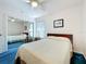 Bright bedroom featuring a ceiling fan and mirrored closet doors at 25044 Cranes Roost Cir, Leesburg, FL 34748