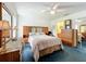 A comfortable bedroom with a mirrored closet and a ceiling fan at 25044 Cranes Roost Cir, Leesburg, FL 34748