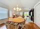 Comfortable dining area adjacent to the living room and featuring a light fixture at 25044 Cranes Roost Cir, Leesburg, FL 34748