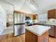 Modern kitchen with stainless appliances, an island, and wood cabinets at 25044 Cranes Roost Cir, Leesburg, FL 34748