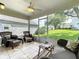 Screened lanai featuring tile flooring, comfortable seating, and a ceiling fan for added comfort at 25044 Cranes Roost Cir, Leesburg, FL 34748
