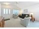 The living room is bright and has a double door entry and plush carpeting at 25044 Cranes Roost Cir, Leesburg, FL 34748