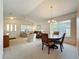Inviting living room with a dining area, comfortable seating, and natural light from the windows at 25044 Cranes Roost Cir, Leesburg, FL 34748