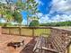 Cozy back deck featuring a swing and small table, perfect for enjoying the serene outdoor views at 25540 Belle Helene, Leesburg, FL 34748