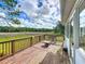 Outdoor deck with seating area, offering scenic views of the backyard and beyond at 25540 Belle Helene, Leesburg, FL 34748