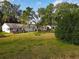 Aerial view of a spacious backyard surrounded by mature trees and lush greenery, providing ample privacy at 25540 Belle Helene, Leesburg, FL 34748