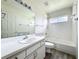 Bright bathroom features a vanity, toilet, and shower/tub combo with tiled walls and flooring at 25540 Belle Helene, Leesburg, FL 34748
