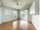 Bedroom with hardwood floors, a ceiling fan, cabinet storage, and a sliding door to the outdoor patio at 25540 Belle Helene, Leesburg, FL 34748