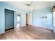 Cozy bedroom with hardwood floors, ceiling fan, closet, and an open entrance to other rooms at 25540 Belle Helene, Leesburg, FL 34748
