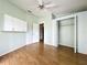 Bedroom with hardwood floors, ceiling fan, closet, and cabinet storage perfect for staying organized at 25540 Belle Helene, Leesburg, FL 34748