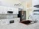 Modern kitchen with stainless steel appliances, granite countertops, and ample cabinet space at 25540 Belle Helene, Leesburg, FL 34748