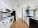 Stylish kitchen with stainless appliances, granite counters and white cabinets and a nice backsplash at 25540 Belle Helene, Leesburg, FL 34748