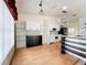 Spacious open plan with hardwood floors, bright open kitchen, and a kitchen island with breakfast bar seating at 25540 Belle Helene, Leesburg, FL 34748
