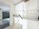 Functional laundry room with washer, dryer, and sink, adjacent to the garage entrance at 25540 Belle Helene, Leesburg, FL 34748