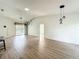 Spacious living area with modern wood-look flooring, a ceiling fan, and sliding glass doors at 25540 Belle Helene, Leesburg, FL 34748