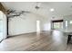 Spacious living room with hardwood floors, vaulted ceilings, natural light, and an accent wall decal at 25540 Belle Helene, Leesburg, FL 34748