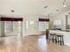 Inviting home interior with lots of natural light, hardwood floors, and a view of the kitchen area at 25540 Belle Helene, Leesburg, FL 34748