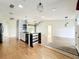 Bright living room featuring an open floor plan, hardwood floors and modern light fixtures at 25540 Belle Helene, Leesburg, FL 34748