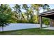 Fenced backyard showing the home and surrounding trees, providing privacy and a natural setting at 27 Perch Dr, Kissimmee, FL 34759
