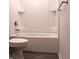 Bathroom with toilet and tub/shower combination featuring white tile at 27 Perch Dr, Kissimmee, FL 34759