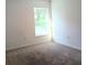 Carpeted bedroom with a window providing natural light at 27 Perch Dr, Kissimmee, FL 34759